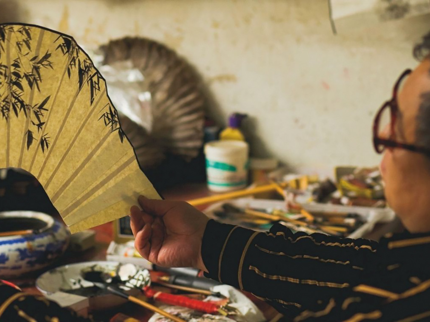 Man making fans by hand